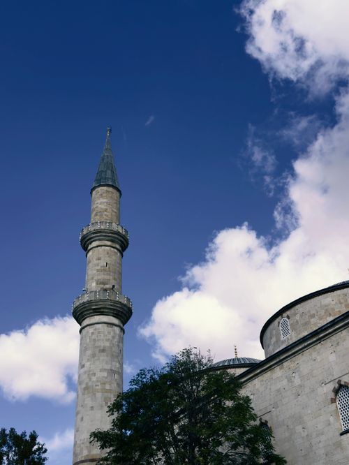 Free A beautifully detailed minaret reaching into a bright blue sky, capturing architectural elegance in Edirne, Turkey. Stock Photo