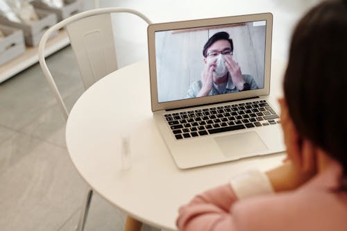 Free Woman In A Video Call With A Covid-19 Patient Stock Photo
