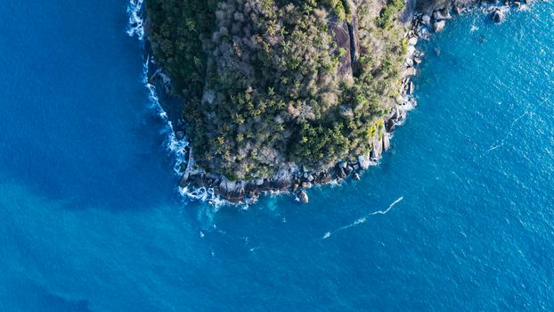 Stunning aerial shot of a lush peninsula surrounded by the vibrant blue ocean in Brazil.