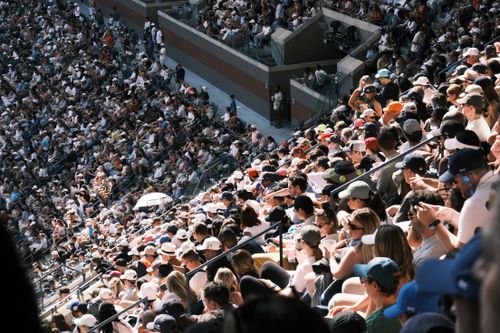 Free A large crowd of spectators in a stadium enjoying a live outdoor event during the day. Stock Photo