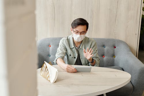 Free Man Wearing A Face Mask Having A Video Call Stock Photo