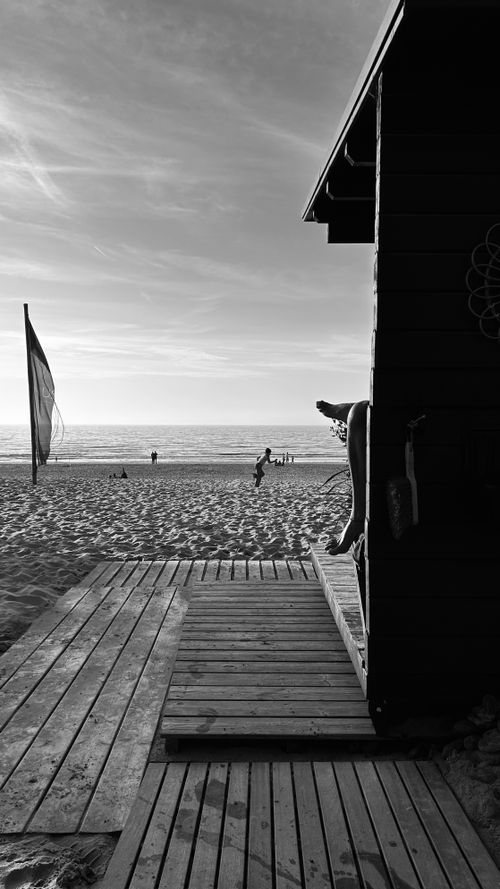 Free Serene black and white photograph of a beach in Zandvoort, Netherlands, capturing a tranquil seascape. Stock Photo