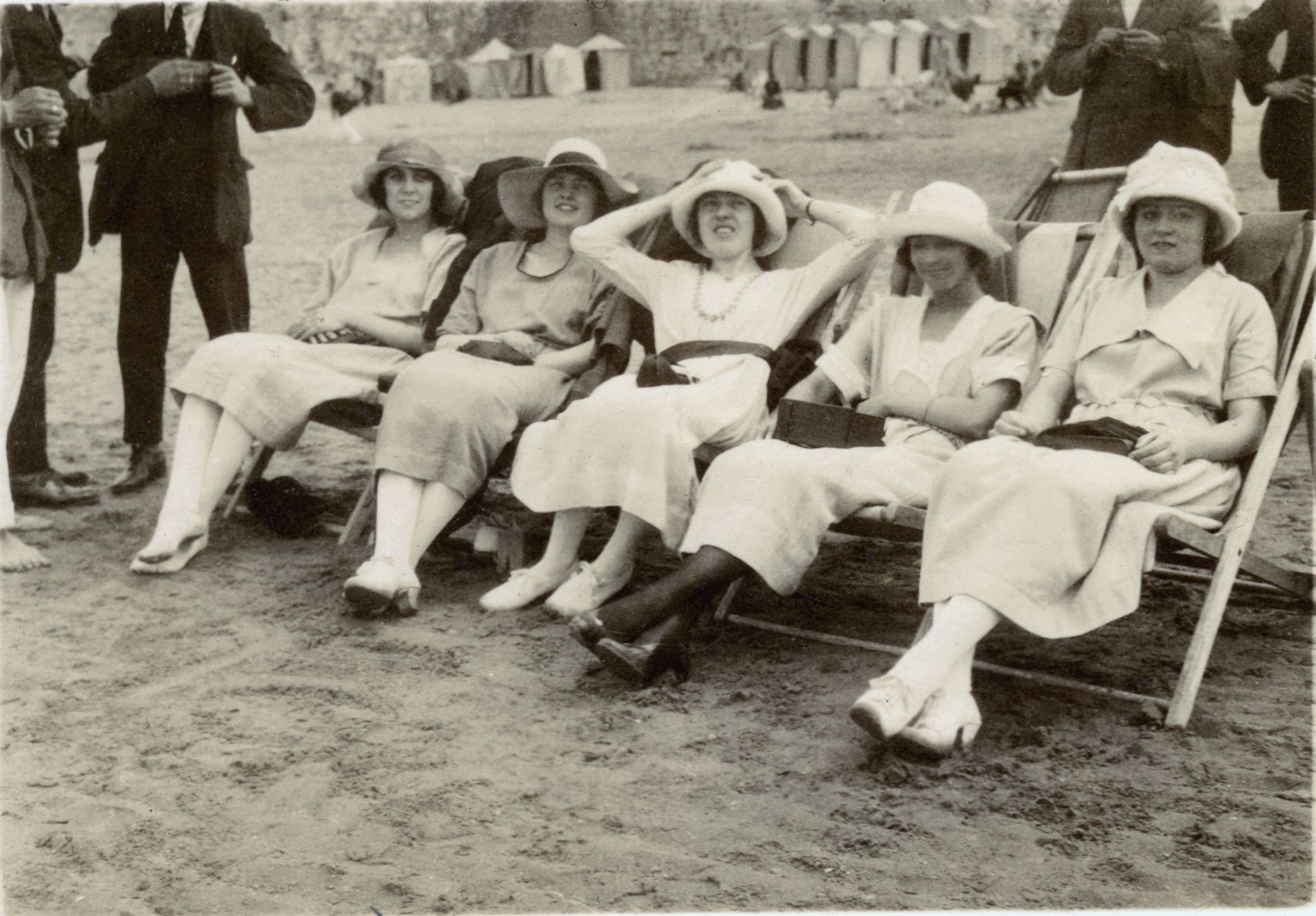 Grayscale Photo of Women Sitting on A Folding Chair