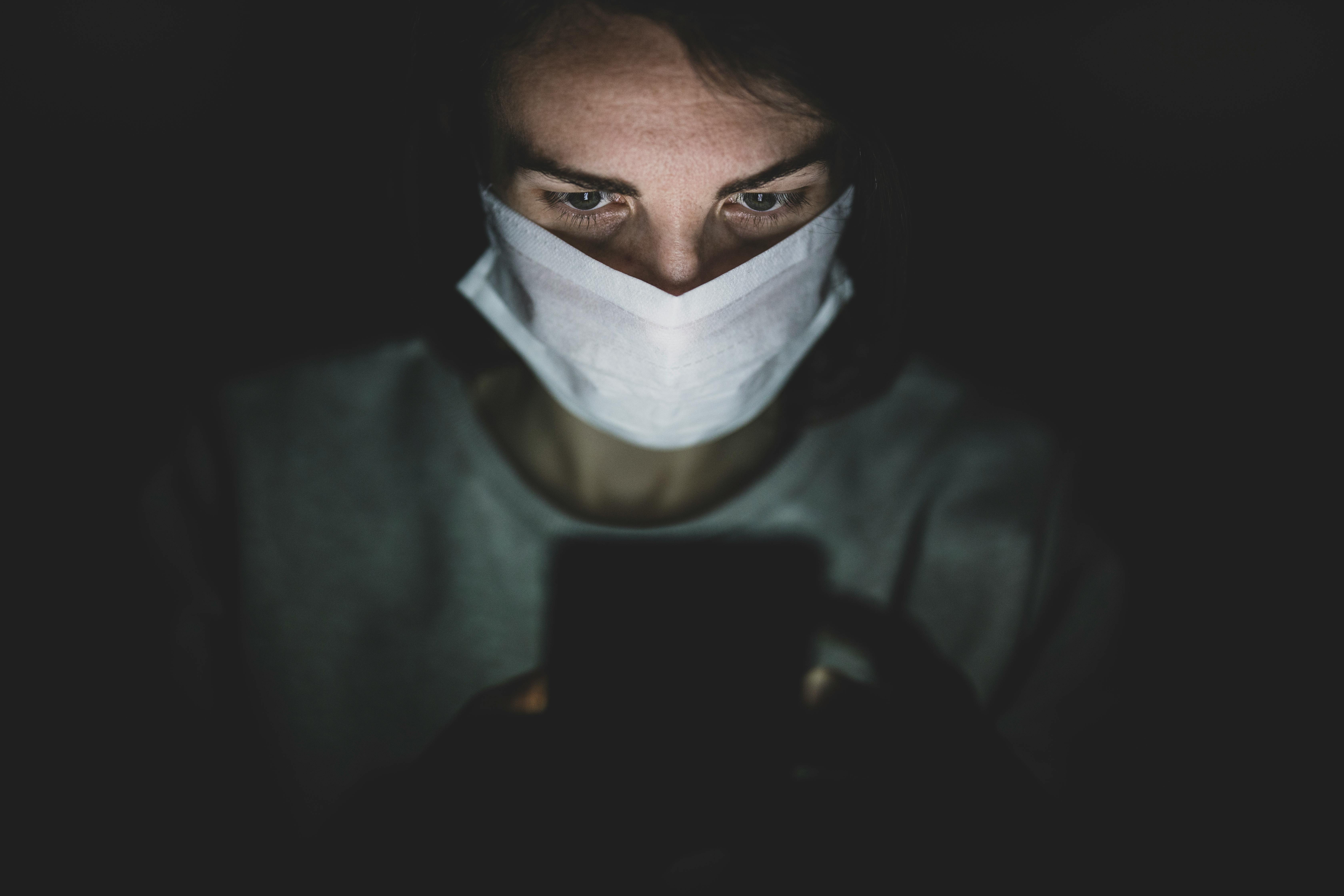 Download Man Wearing Face Mask Using His Phone In The Dark · Free ...