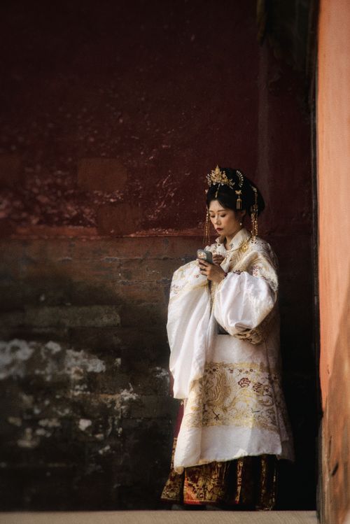 Free Woman in traditional Asian attire in a historical setting, embodying cultural elegance. Stock Photo