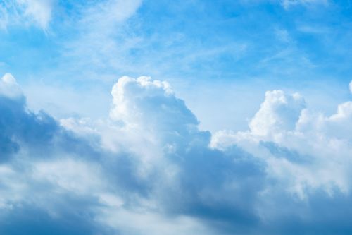 Free Vibrant cumulus clouds set against a clear blue sky, capturing a serene summer day. Stock Photo