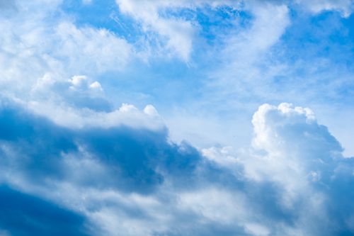 Free A bright and clear sky featuring white cumulus clouds against a vivid blue backdrop, ideal for natural and serene themes. Stock Photo