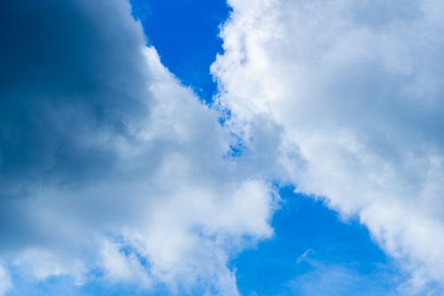 Free A vibrant sky showcasing fluffy white clouds against a bright blue backdrop, capturing a serene moment in nature. Stock Photo