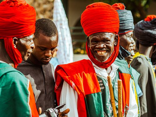 Free Men in vibrant traditional Nigerian attire during a festive gathering in Jigawa. Stock Photo