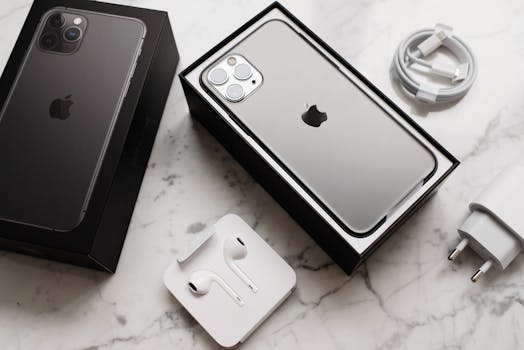 A sleek smartphone unboxed with accessories displayed on a marble surface, showcasing modern technology.