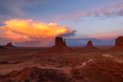 Free Breathtaking view of Monument Valley at sunset with dramatic clouds and vibrant colors. Stock Photo