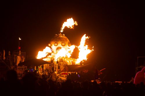 Free Giant robot sculpture with fire at nighttime festival event. Stock Photo