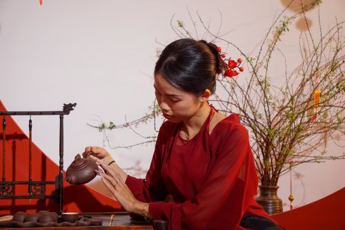 Free A Vietnamese woman in traditional attire skillfully crafting a teapot. Captured in Hue, Vietnam. Stock Photo