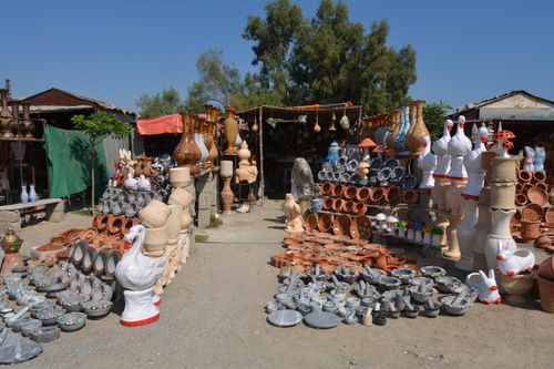 Free Colorful display of handcrafted pottery and art in a bustling outdoor market in Taxila, Pakistan. Stock Photo