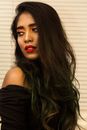 Alluring young ethnic woman looking away