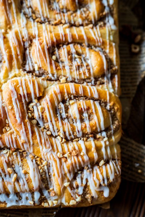 Free Freshly baked cinnamon rolls with icing drizzle, perfect for dessert or breakfast. Stock Photo