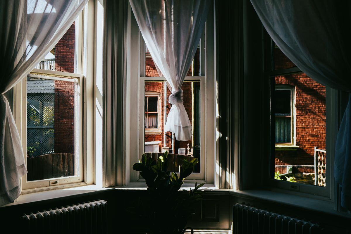 Sunlight through a traditional sash window in a period home, showing the value of efficient glazing