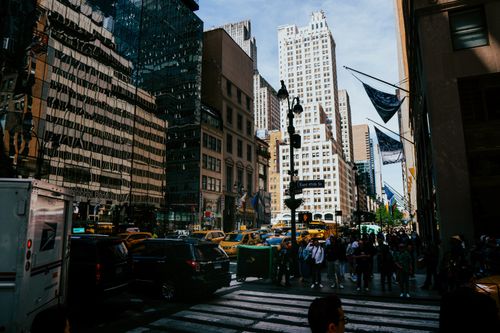 Free Bustling New York City street with taxis and skyscrapers under a clear blue sky. Stock Photo