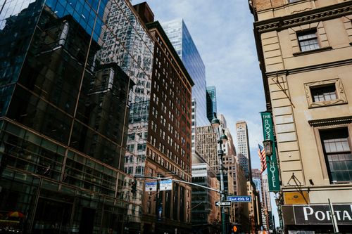 Free Dynamic street view of New York City's iconic skyscrapers reflecting urban life. Stock Photo