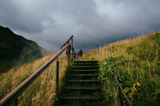 A captivating view of the Skogafoss hiking trail in Iceland's lush autumn landscape.