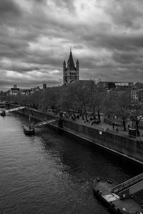 Free Black and white view of Cologne with the Rhine River and iconic church. Stock Photo