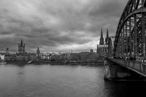 Free Striking black and white view of Cologne Cathedral and Hohenzollern Bridge. Stock Photo