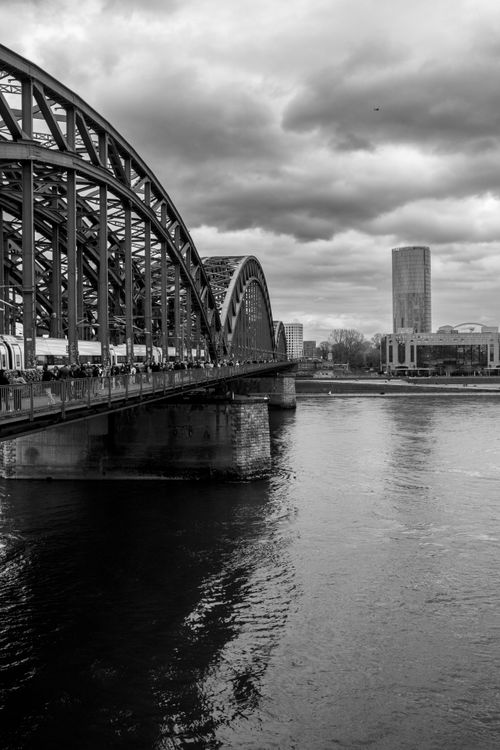 Free Black and white view of the Hohenzollern Bridge spanning the Rhine River in Cologne, Germany. Stock Photo
