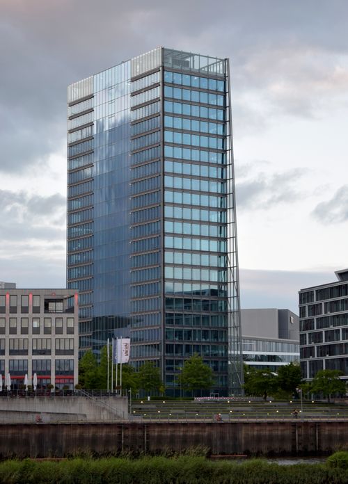 Free A contemporary glass skyscraper in Bremen, Germany under a cloudy sky. Stock Photo