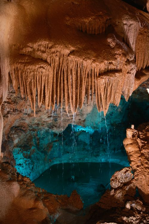 Free Explore the stunning stalactites and turquoise waters in Mira de Aire caves, Portugal. Stock Photo