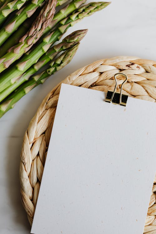 Paper sheet fastened by paper clip on wicker table mat