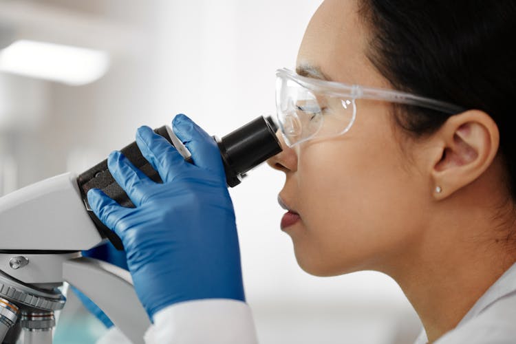 A Woman Using Microscope