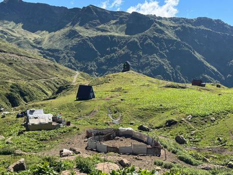 Scenic view of rural huts amidst the lush green mountains of Abkhazia.