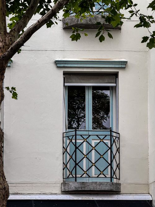Free Elegant window with decorative balcony and tree reflection in Cape Town, South Africa. Stock Photo