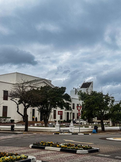 Free Street view of historic buildings in Cape Town with cloudy skies, showcasing classic architecture. Stock Photo