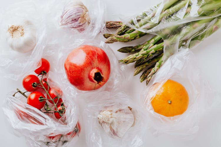 Collection Of Fresh Fruits And Vegetables Put On White Table