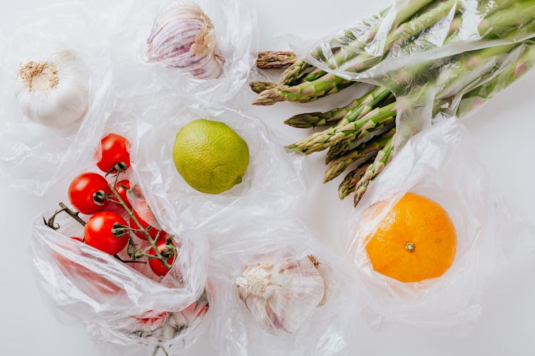 Assortment Of Fresh Vegetables And Fruits Put In Plastic Bags