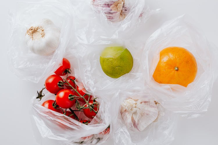 Fresh Vegetables And Citrus Fruits Put In Plastic Bags