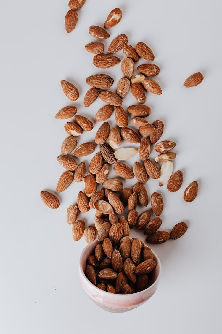 Scattered Raw Almonds Scattered On White Surface