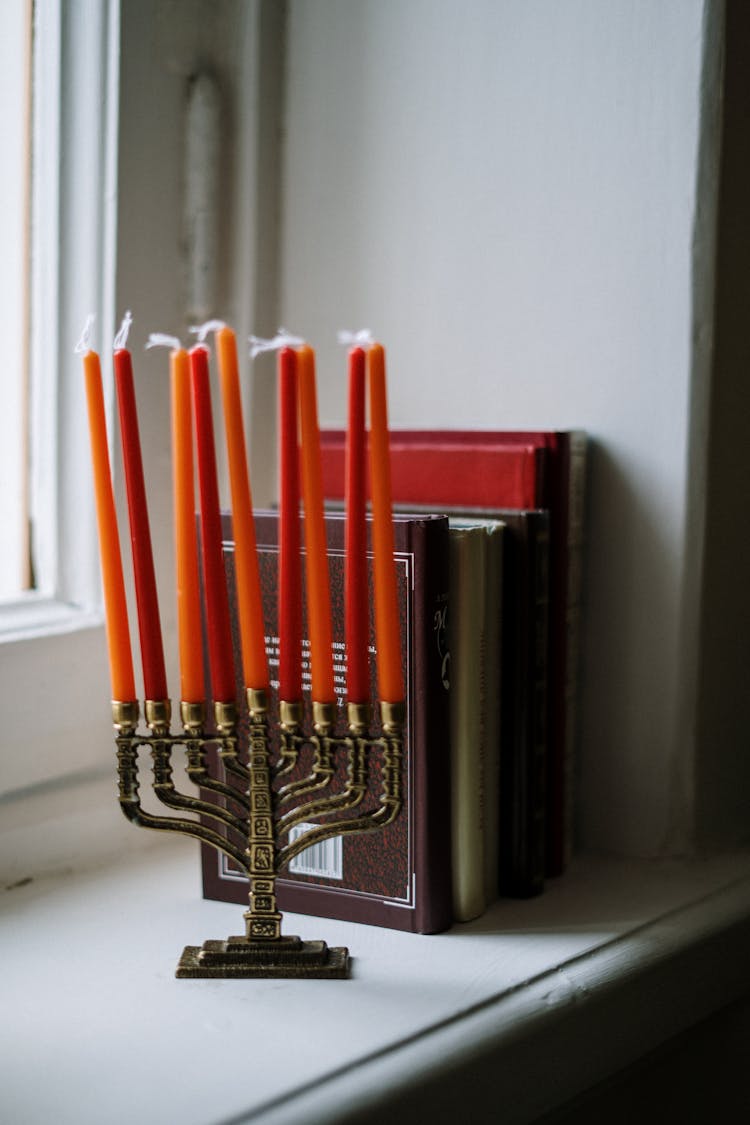 Menorah And Books Next To A Window