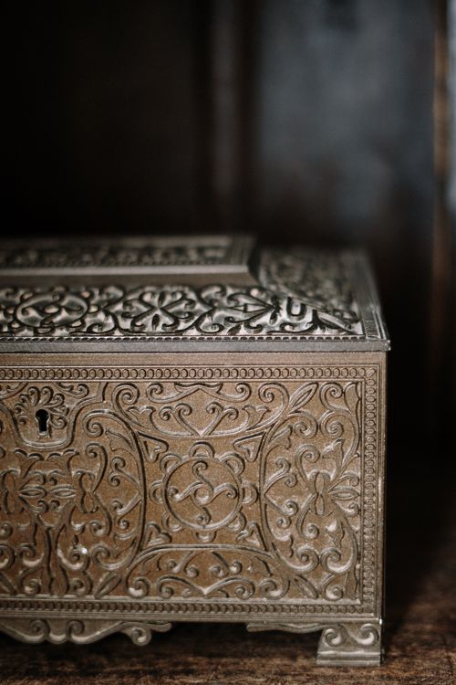 Free Close-up of an antique brass box with ornate carvings, ideal for decor and antique collections. Stock Photo