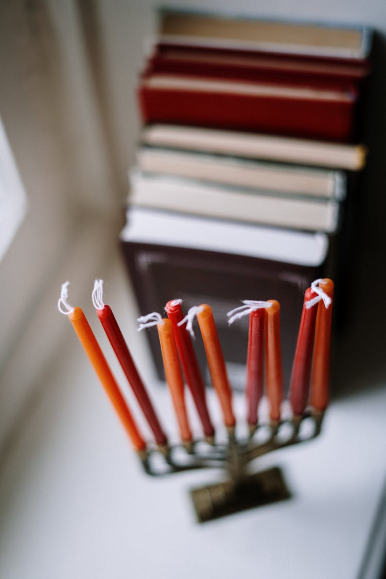 Menorah And Books Next To A Window