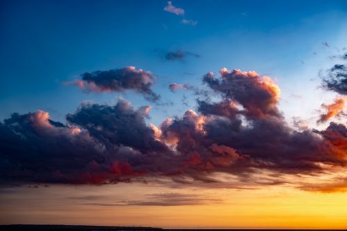Free Mesmerizing sunset in Bali capturing a dramatic sky with vibrant clouds during golden hour. Stock Photo