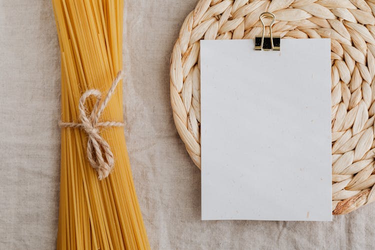 Empty Paper And Tied Pasta On Kitchen Table