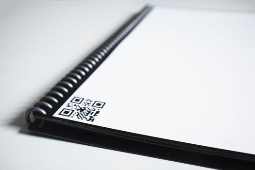 Black Spiral Notebook With Bar Code on Table