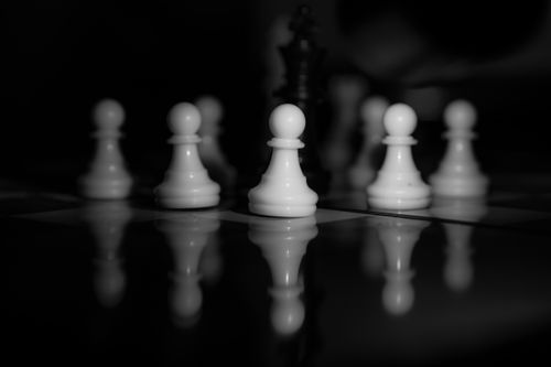 Free A dramatic black and white image of chess pawns with reflections on the chessboard in Bursa, Türkiye. Stock Photo