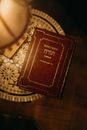 Book in Hebrew Next to a Lamp