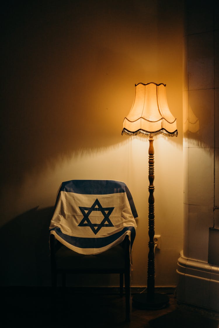 Flag Of Israel Next To A Floor Lamp