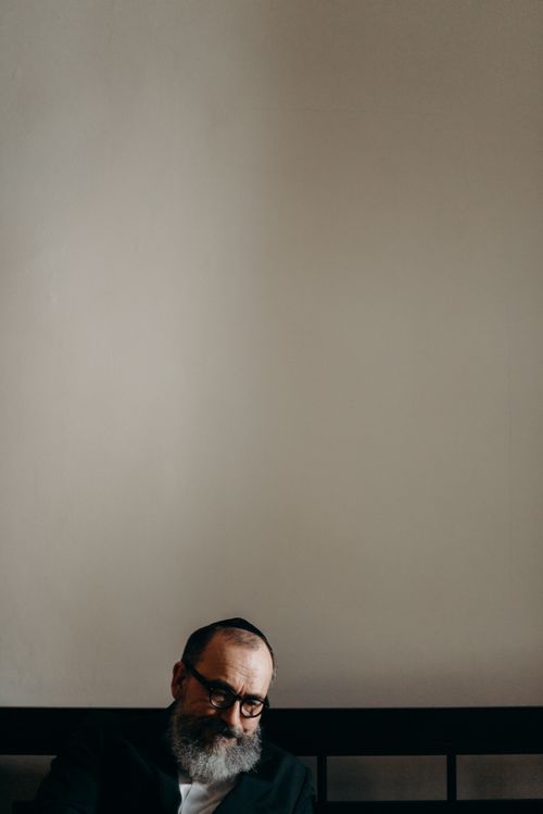 Free An introspective moment captured of an Orthodox Jewish man wearing a kippah indoors. Stock Photo