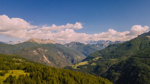 Free Stunning aerial view of a lush green mountain range under a clear blue sky. Stock Photo