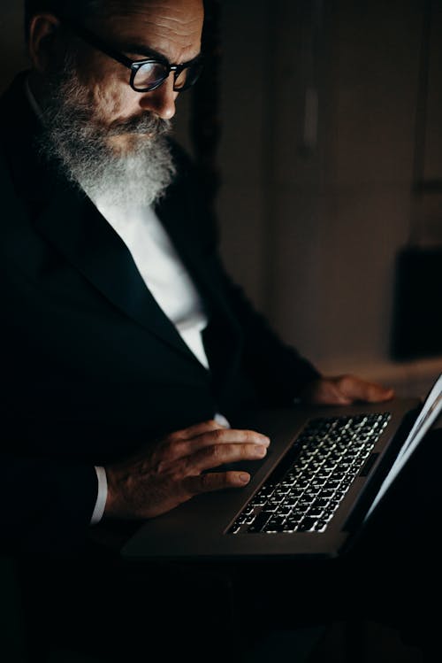 Photo Of An OId Man Using Laptop